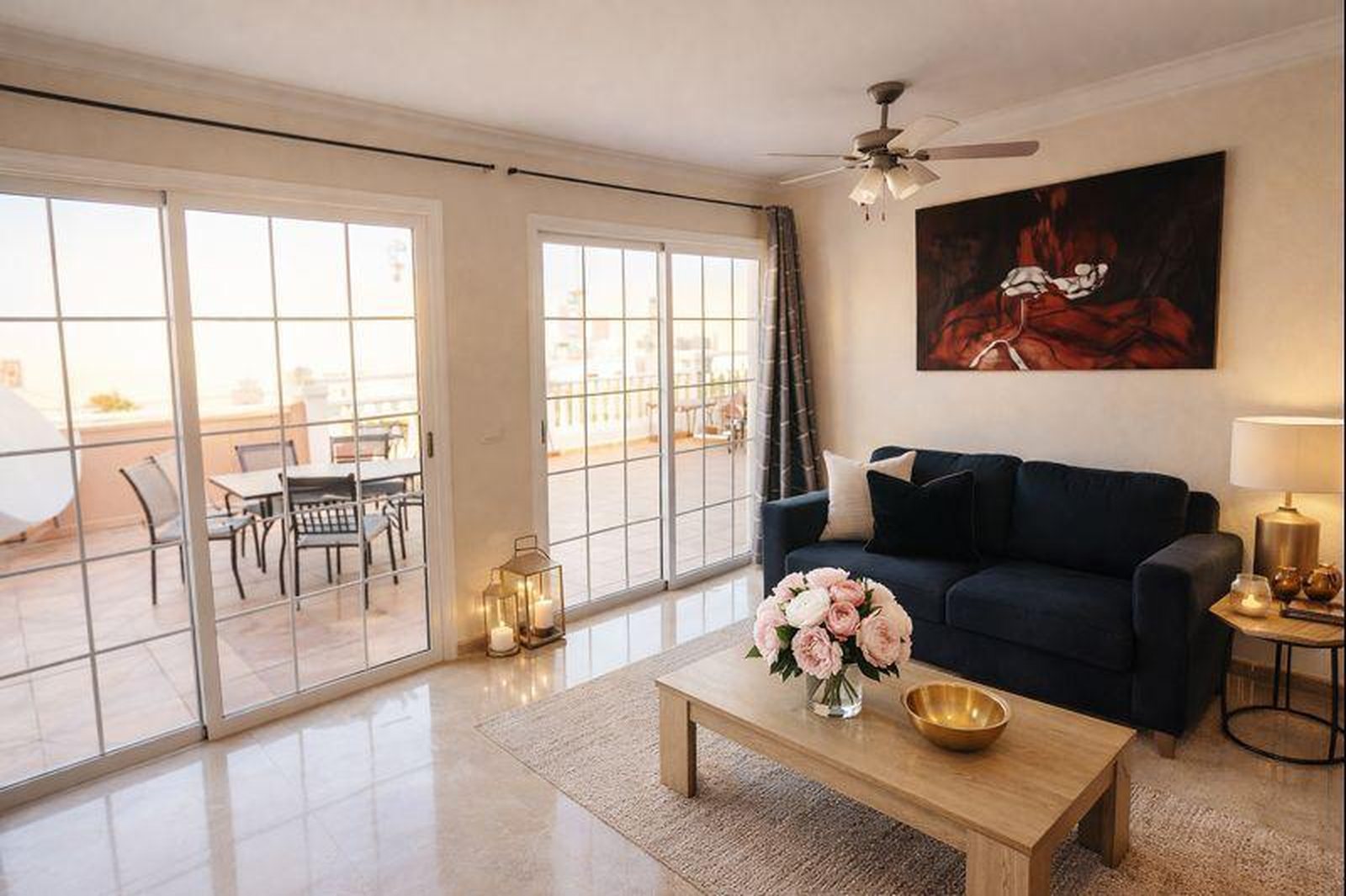 A living room with two doors to the terrace